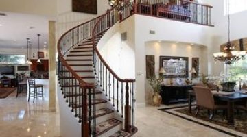 Designed and built by Creative Custom Stairs, this curved staircase was built in Port Charlotte, FL using black cherry treads and painted risers. The Old World black cherry handrail and Old World satin black balusters create remarkable lines. The elegant starting step is a double bullnose black cherry tread.