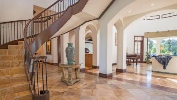 Located in Fort Myers, a curved set of stairs with a "bridge" area leading up to a curved balcony. All Balusters were custom fabricated in a single design using a smooth round bar and one knuckle. Oversized Northern Red Oak newels and customized handrail. Simple exudes elegance.