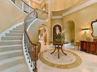 With a vision of old fashioned elegance, this long curved staircase catches all attention in the foyer. Curved staircase with Red Oak handrail and 1st tread balustrade continuing with painted iron balustrades. The carpeted treads and risers softens the look.