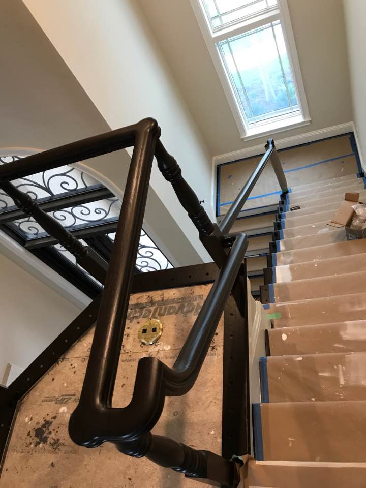 This stairway built in 2017 for a Marco Island home begins with a curved area leading to a switchback is a great example of the creative and custom methods used by the Creative Custom Stairs Team. Photograph shows the protective covering still in place until all finish work has been completed.