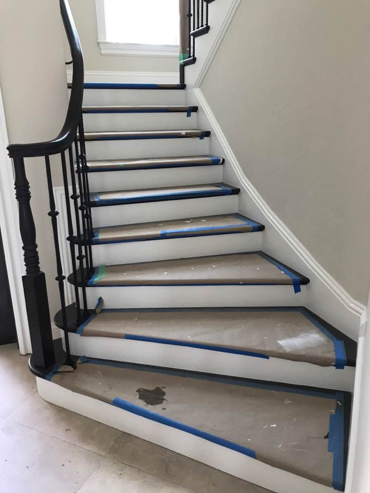 Just built in 2017 this stairway begins with a curved section and has a switchback to meet the unique needs of this home. Photograph shows the protective covering still in place until all finish work has been completed.